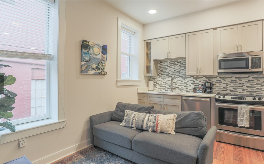 Loft apartment living room with hardwood floors and high ceilings at The Lofts at 119, downtown Norfolk